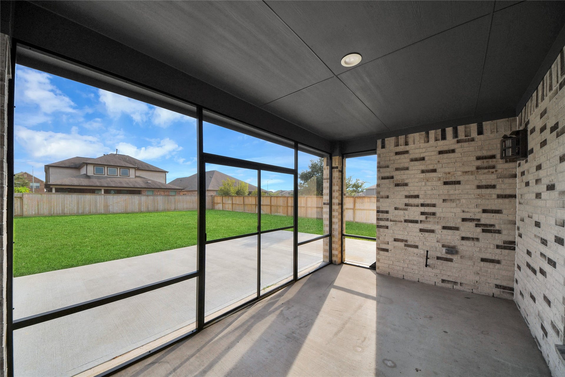23619 Iris Field Court, Katy, TX 77493 Enclosed back porch creates a comfortable extension of the living space, perfect for relaxing, entertaining, and enjoying the backyard year-round.