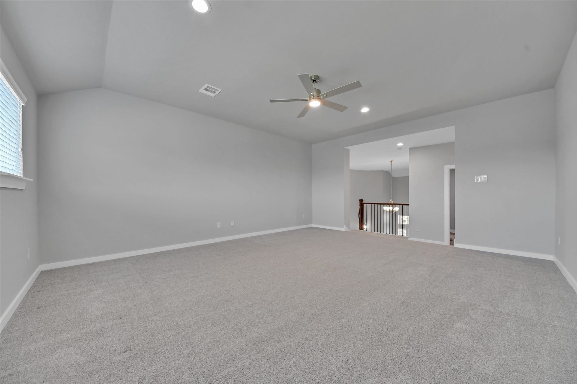 23619 Iris Field Court, Katy, TX 77493 Expansive upstairs game room with soaring ceilings, soft carpeting, and flexible space ideal for a media lounge, game tables, or family entertainment.