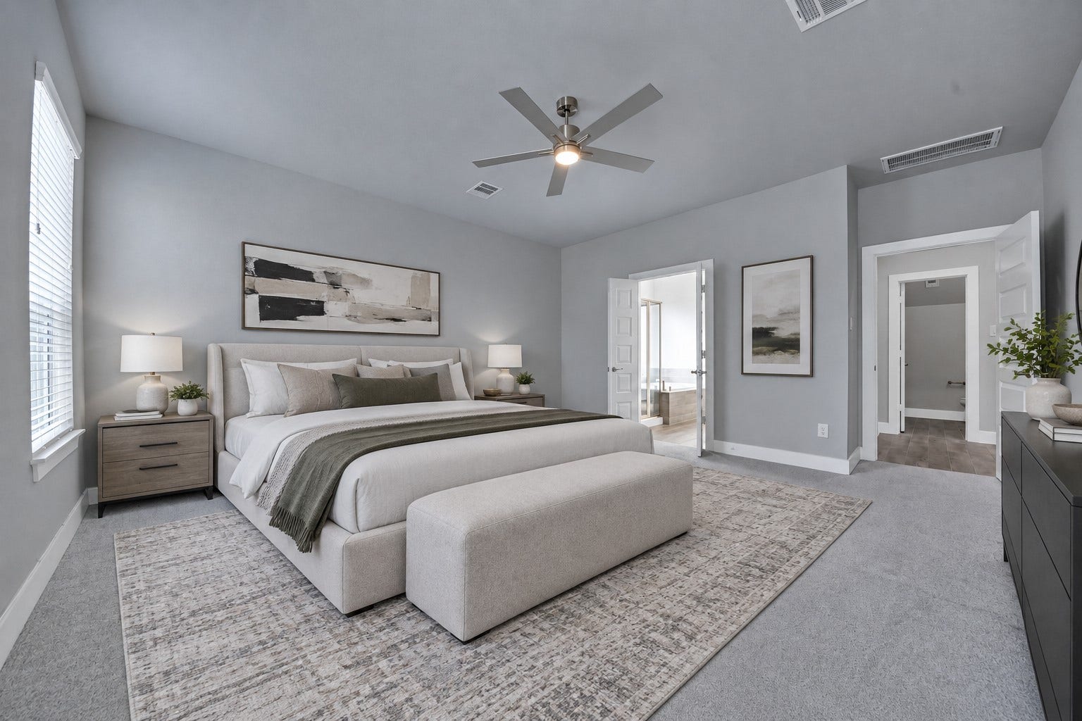 23619 Iris Field Court, Katy, TX 77493 Virtually Staged. Spacious primary retreat featuring high ceilings, warm neutral walls, plush carpeting, and large windows that fill the room with natural light.