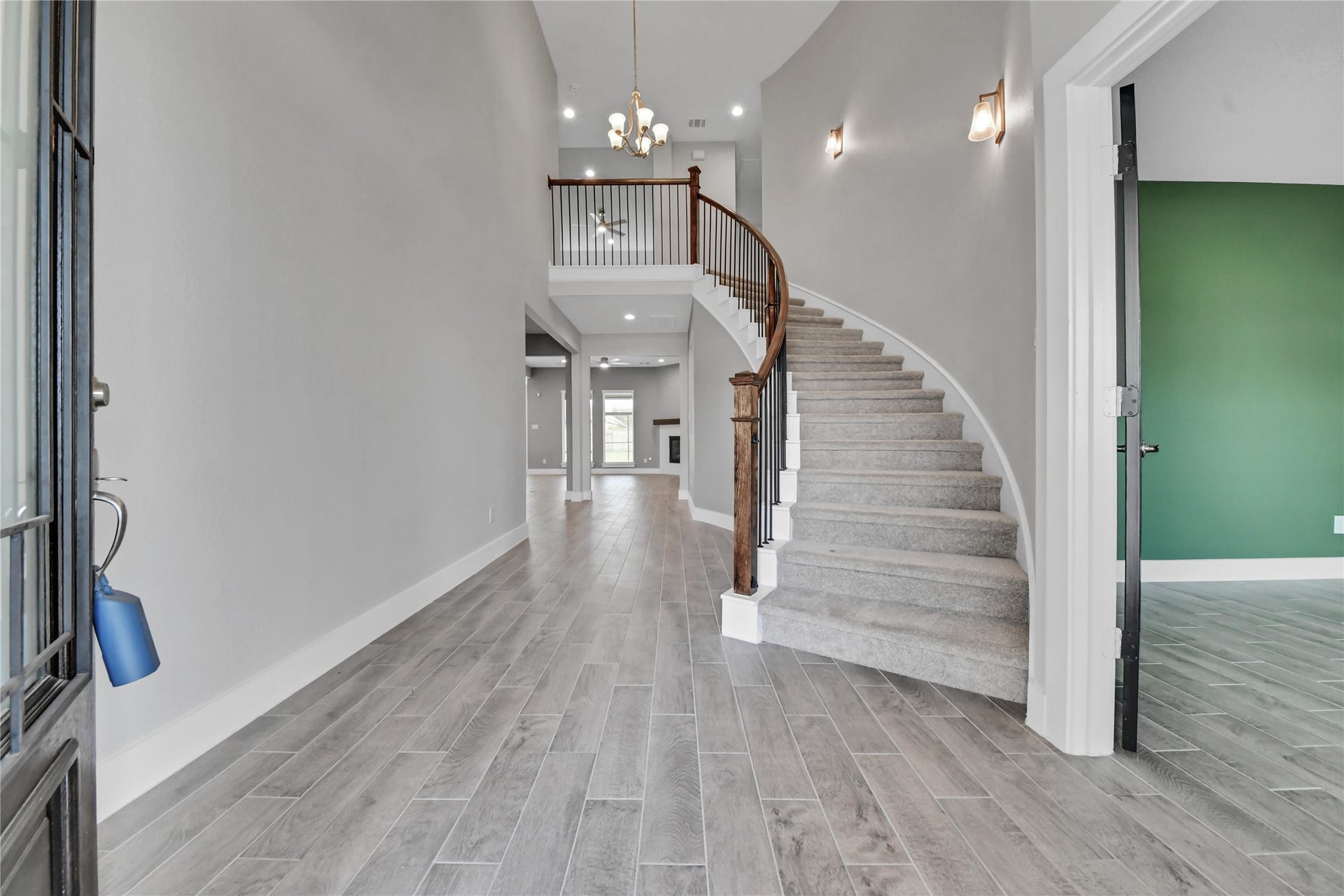 23619 Iris Field Court, Katy, TX 77493 Grand entry welcomes you with soaring ceilings, wood-look tile flooring, and an elegant curved staircase that makes an immediate impression.