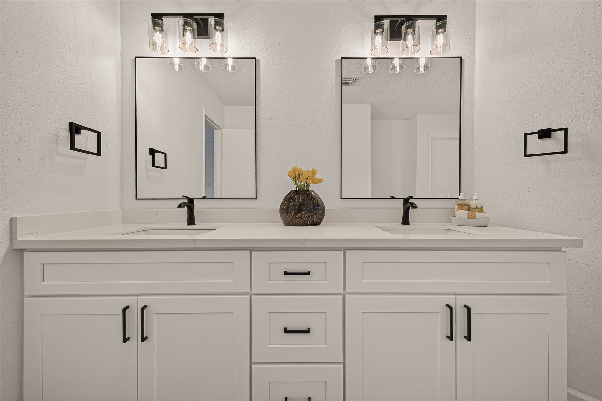 12747 Ashford Knoll Drive, Houston, TX 77082 Double vanity with sleek black fixtures and modern mirrors.