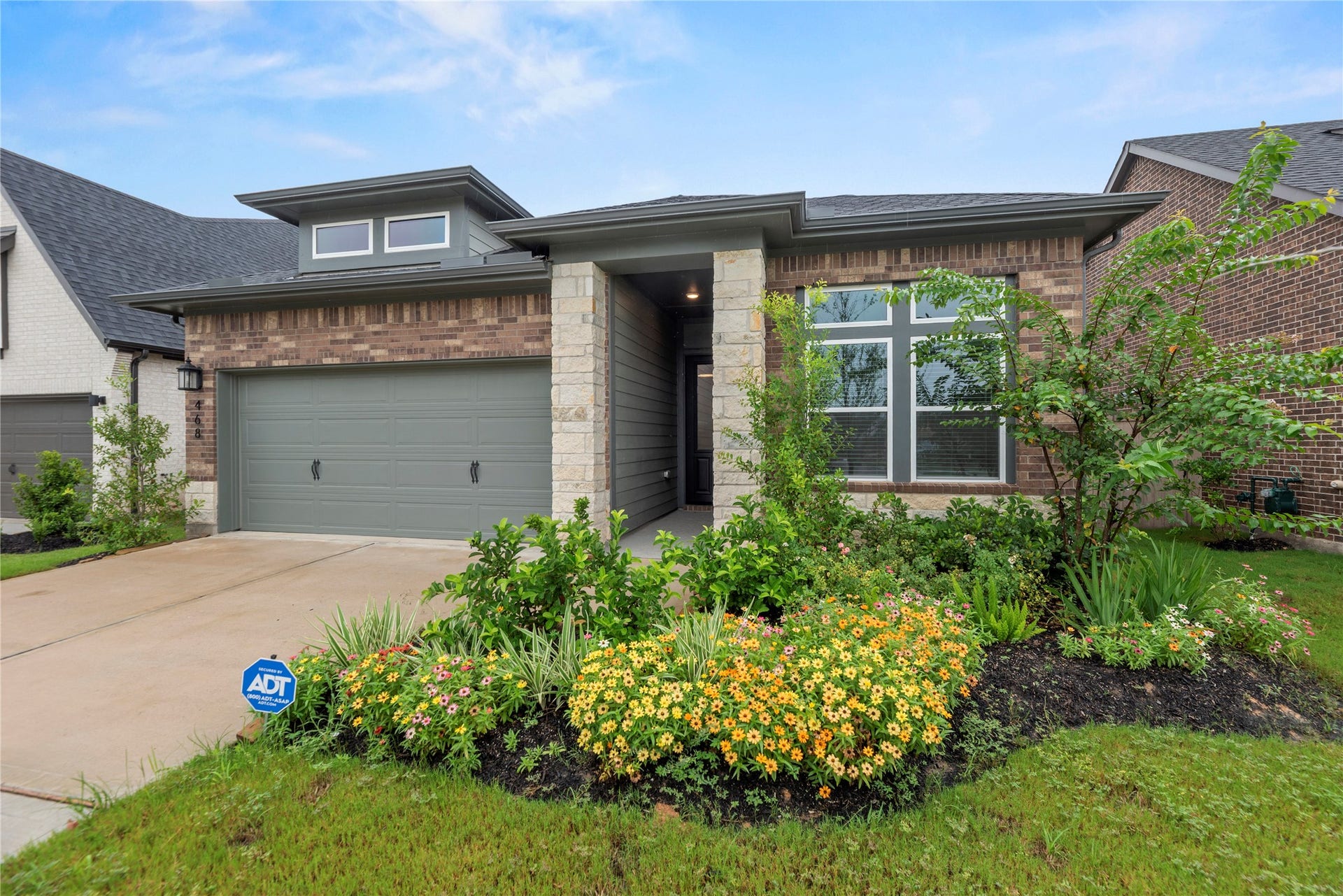468 Harvest Moon Drive, Katy, TX 77493 Attractive landscaping complements front exterior.