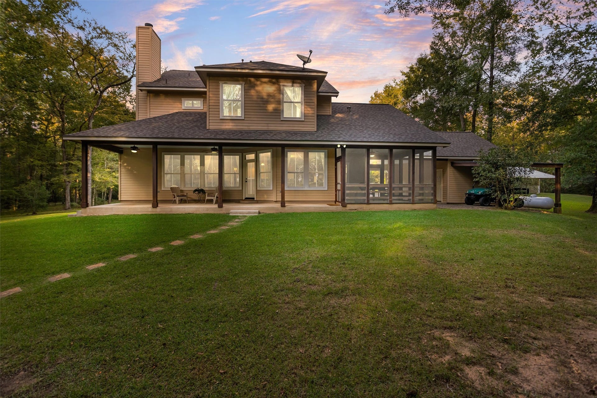 18181 Rabon Chapel Road, Montgomery, TX 77316 The back of the home glowing at sunset