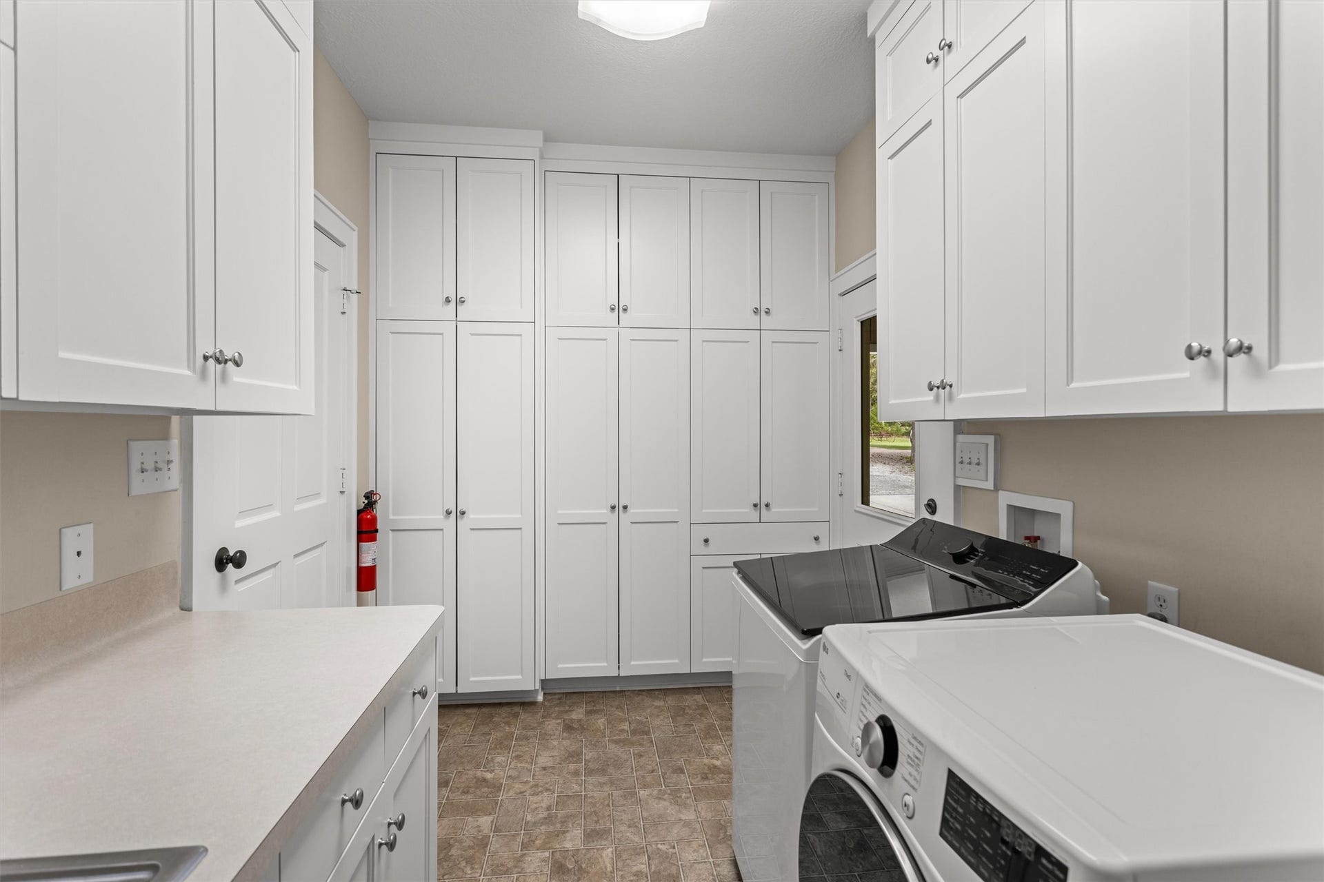 18181 Rabon Chapel Road, Montgomery, TX 77316 Utility room with storage and folding space