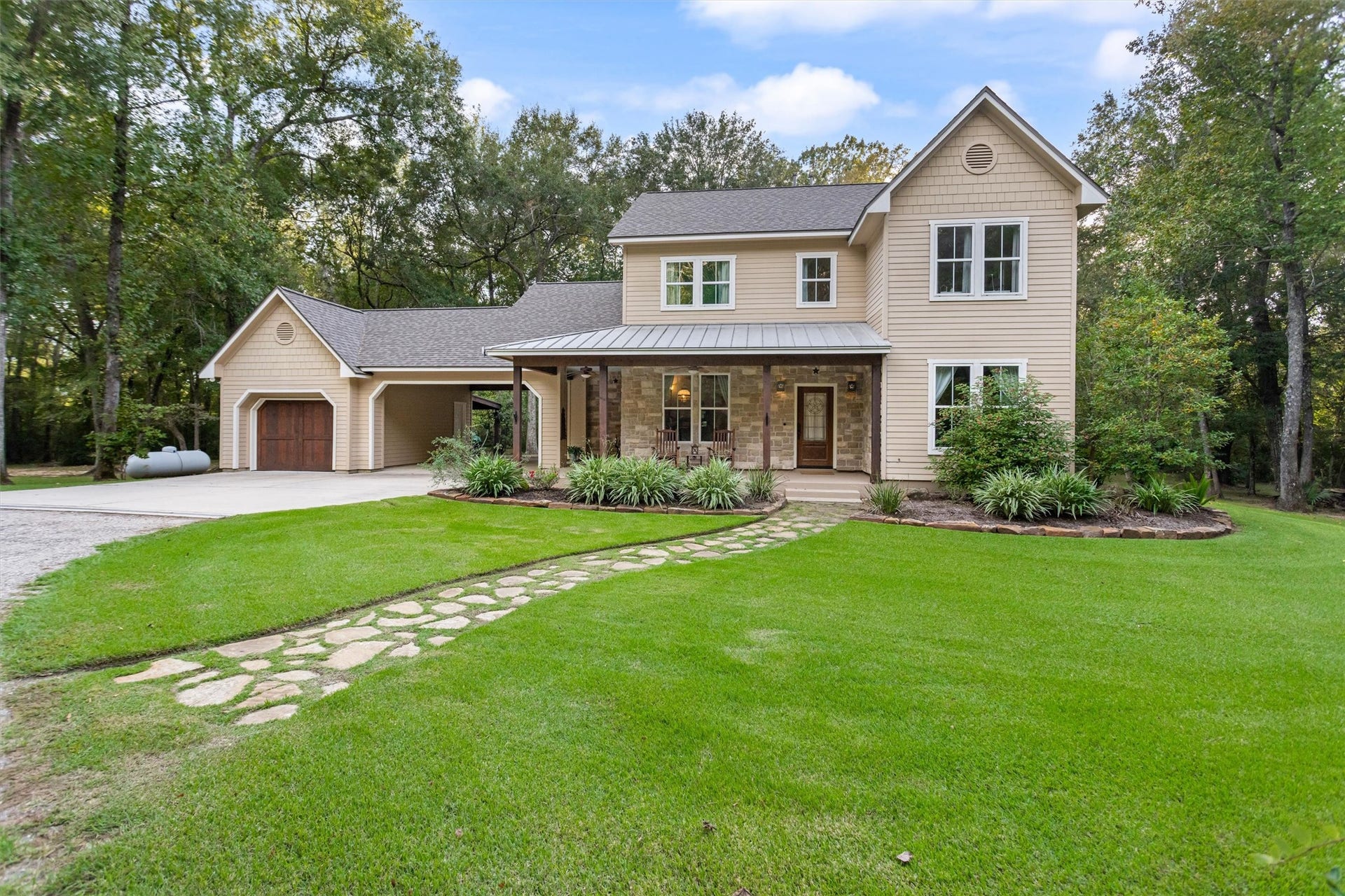 18181 Rabon Chapel Road, Montgomery, TX 77316 Classic two-story with stone accents and a manicured lawn