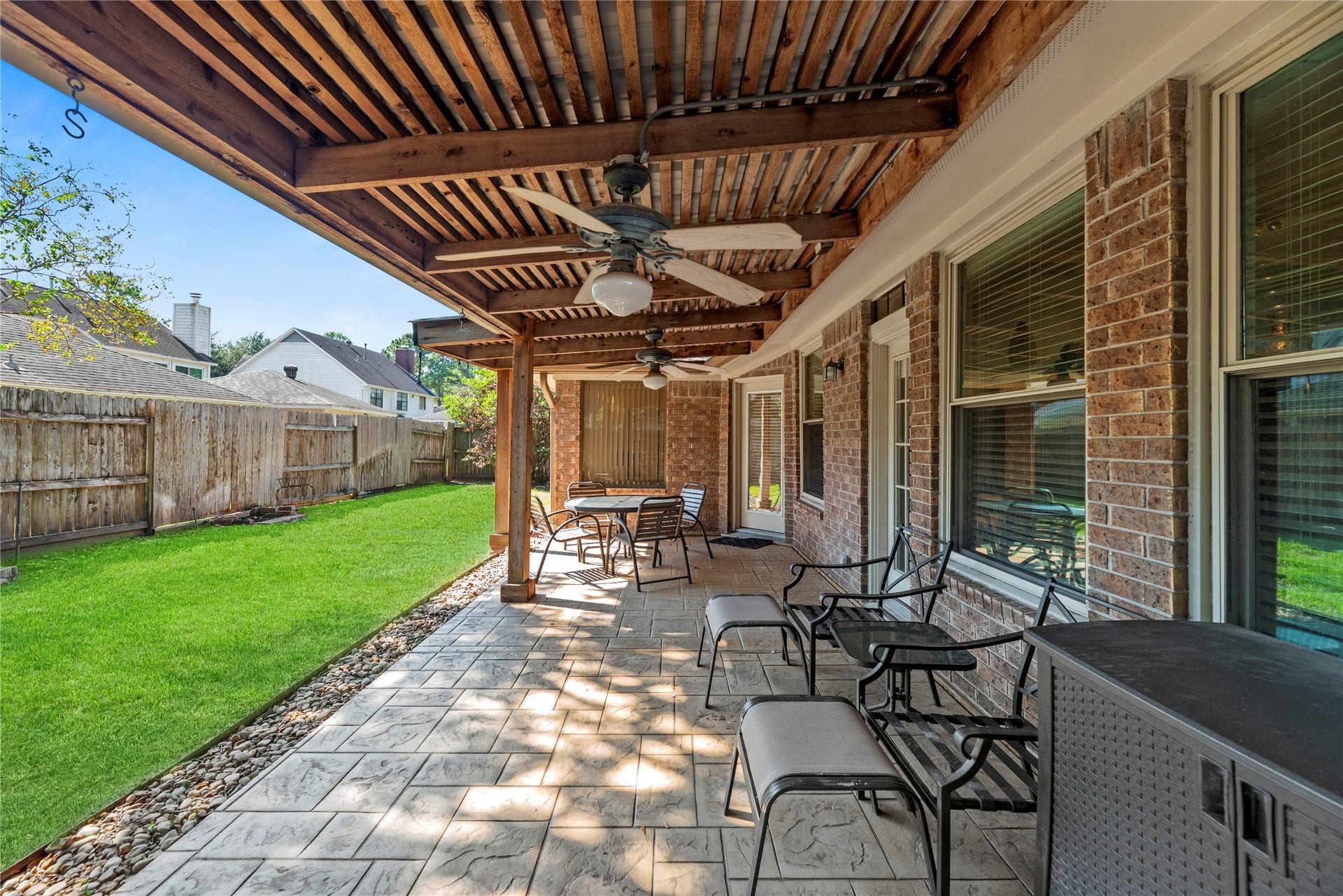 Great sized covered patio with ceiling fans and ample seating. Perfect for outdoor relaxation and entertainment.