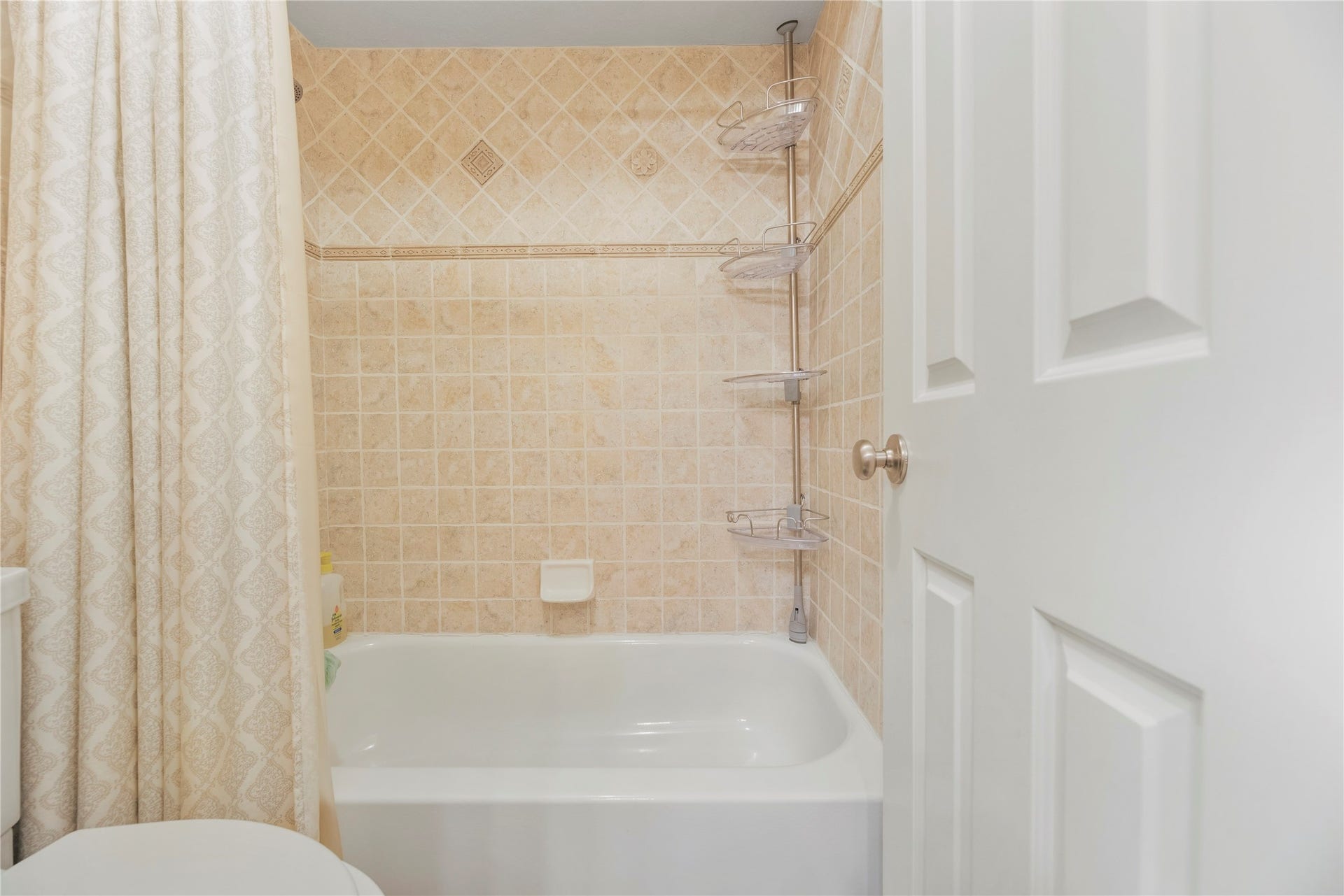 Shower/tub and toilet area of the secondary bathroom.