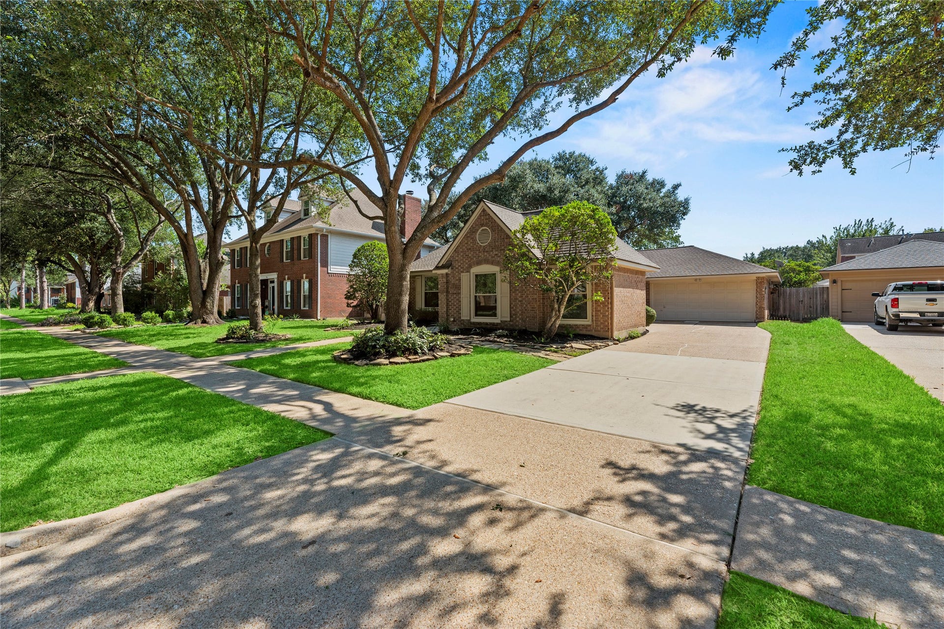 Spacious driveway and well-maintained lawn, offering a serene suburban setting.