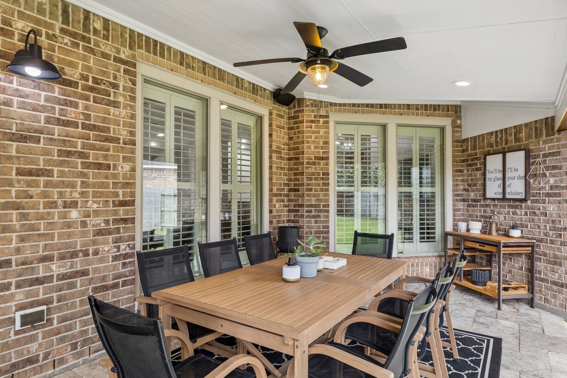 2927 Auburn Creek Lane, League City, TX 77573 Covered outdoor living area with ceiling fan and a comfortable setup overlooking the backyard.