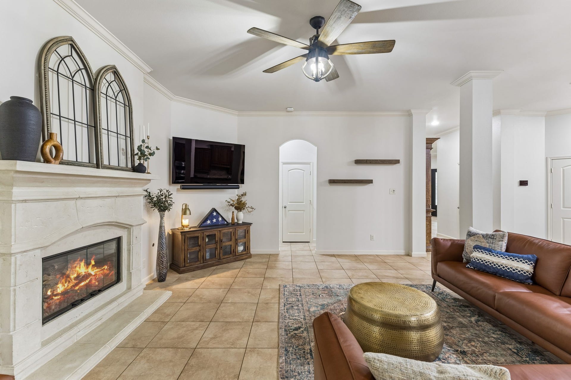 2927 Auburn Creek Lane, League City, TX 77573 Inviting living area featuring a fireplace, ceiling fan, and an open flow to the surrounding living spaces.