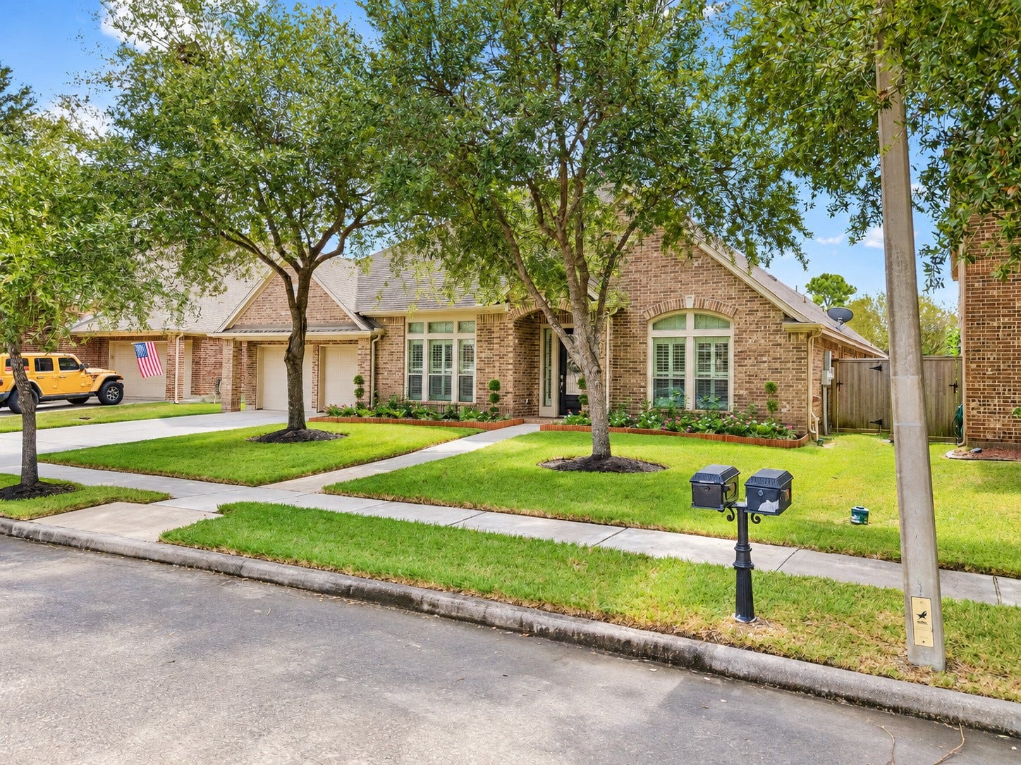 2927 Auburn Creek Lane, League City, TX 77573 Wide street view of the home framed by mature trees and a spacious front lawn.