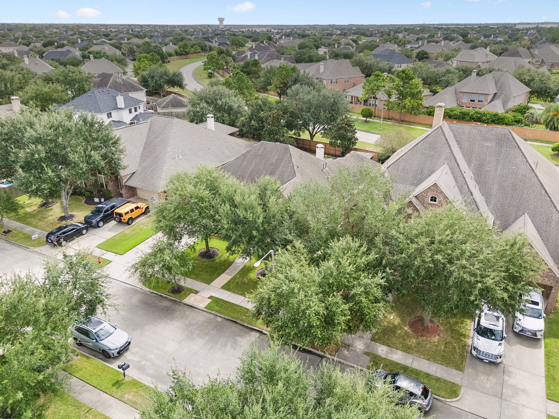 2927 Auburn Creek Lane, League City, TX 77573 Aerial View Aerial perspective highlighting the home, mature trees, surrounding residences, and neighborhood setting.