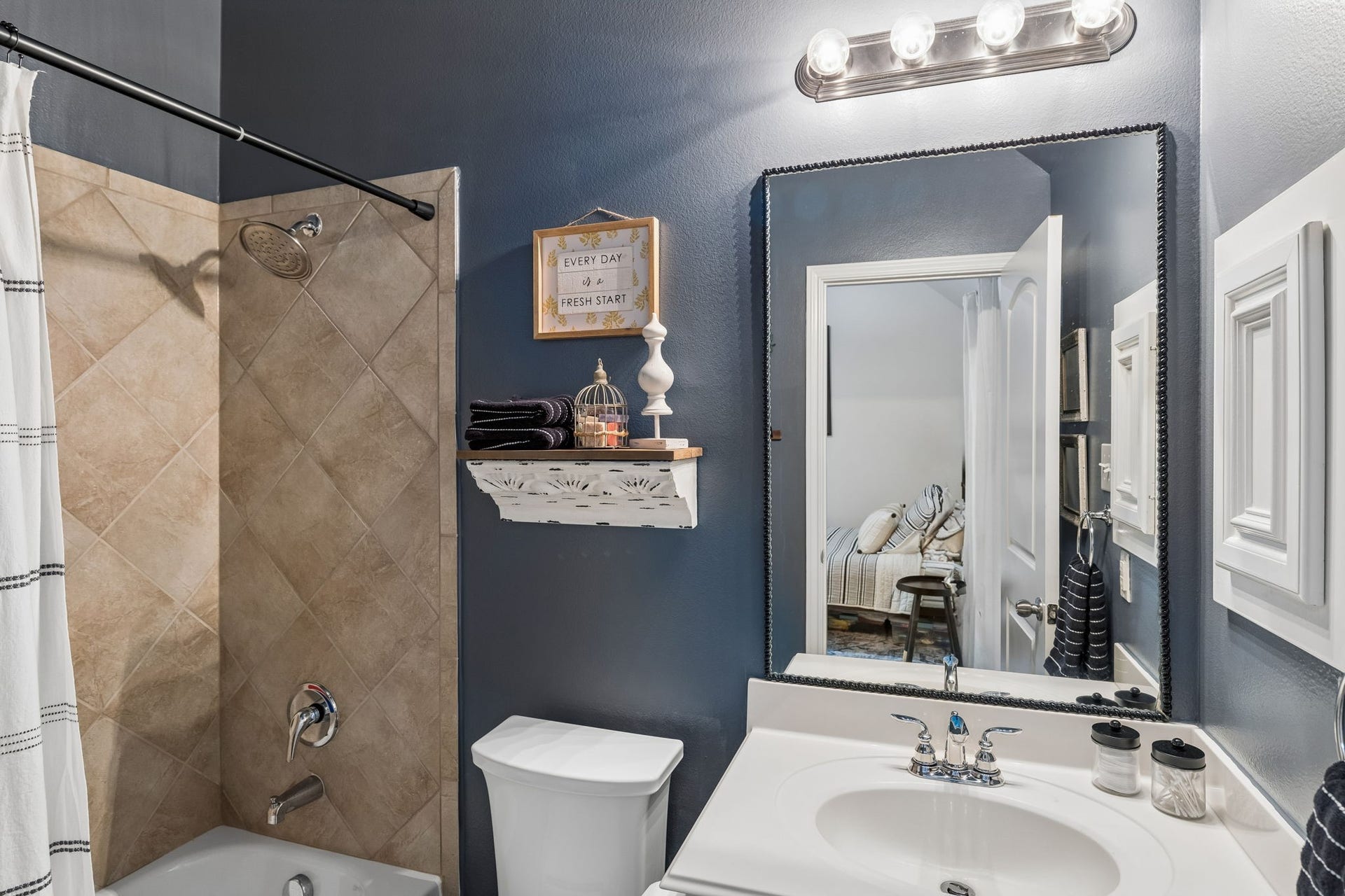 2927 Auburn Creek Lane, League City, TX 77573 Full bathroom with vanity, large mirror, tub/shower combination, and updated finishes.