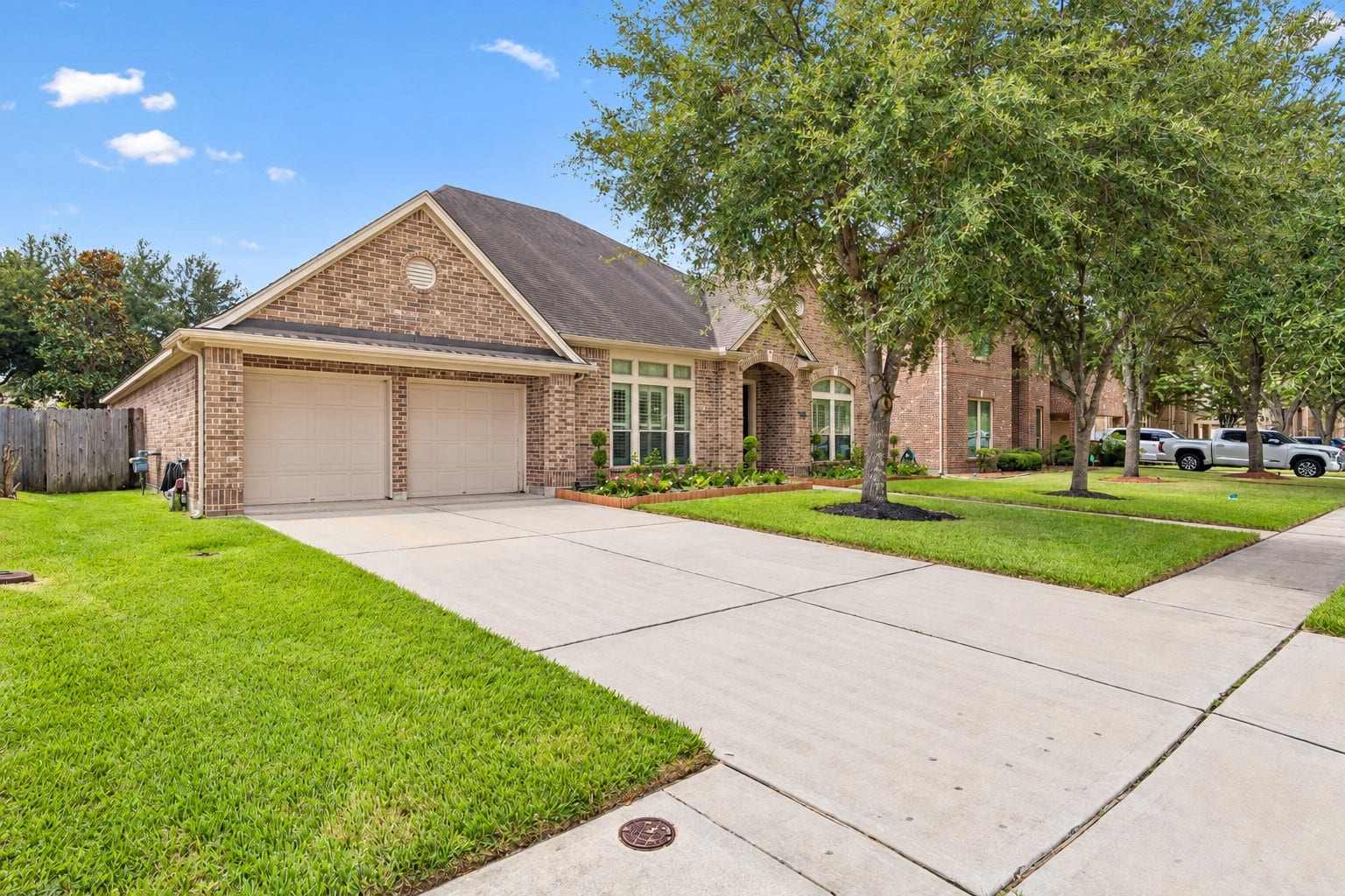 2927 Auburn Creek Lane, League City, TX 77573 Additional front exterior view showcasing the driveway, garage, and well-maintained landscaping.