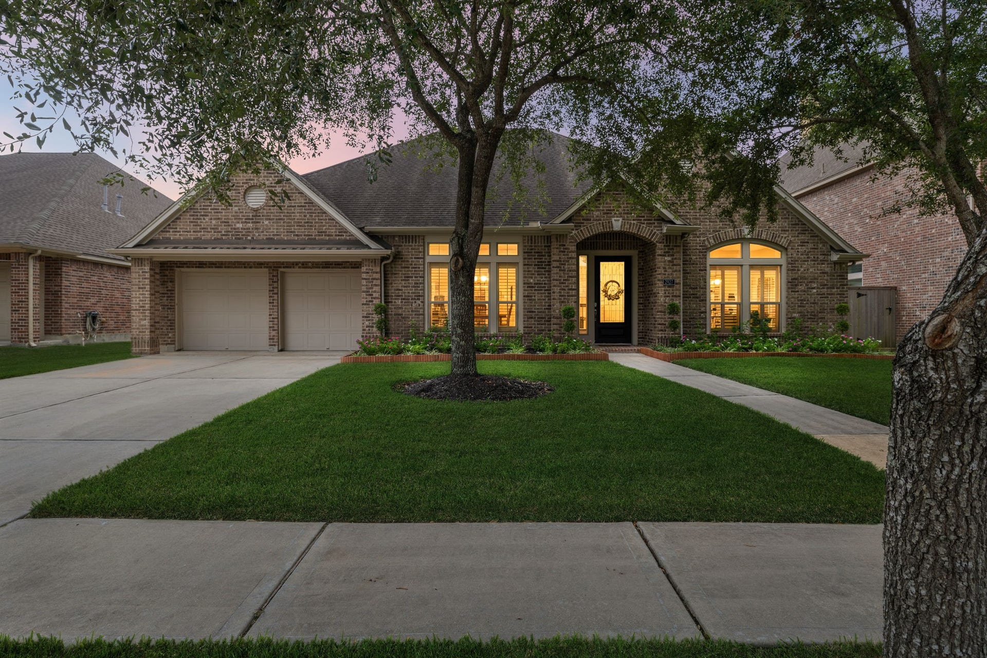 2927 Auburn Creek Lane, League City, TX 77573 Evening exterior view showcasing the homes warm exterior lighting and inviting curb appeal.