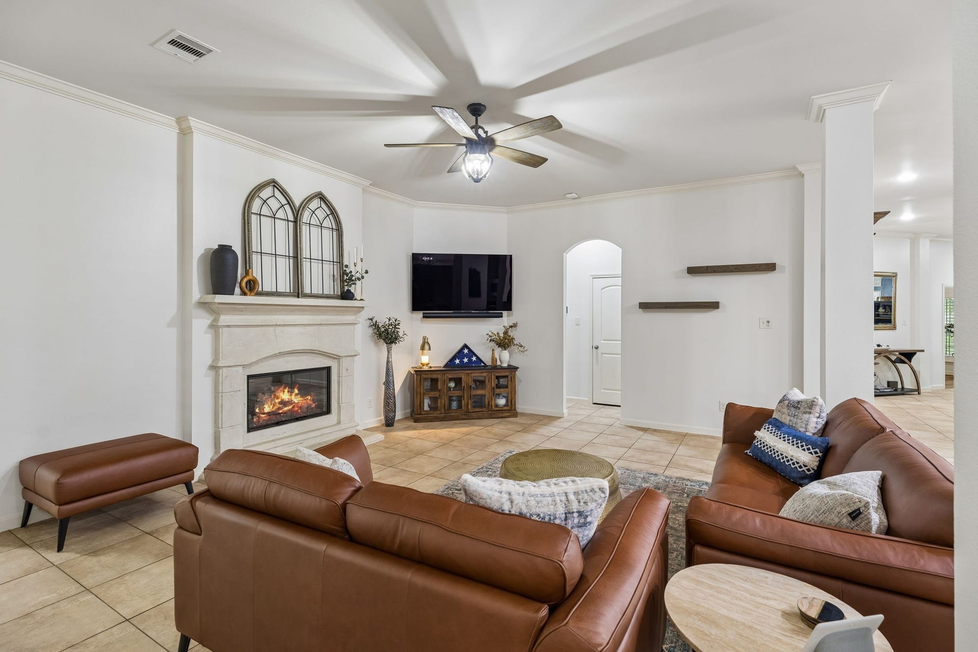 2927 Auburn Creek Lane, League City, TX 77573 Alternate view of the living room highlighting the fireplace, generous seating area, and flow to adjacent spaces.