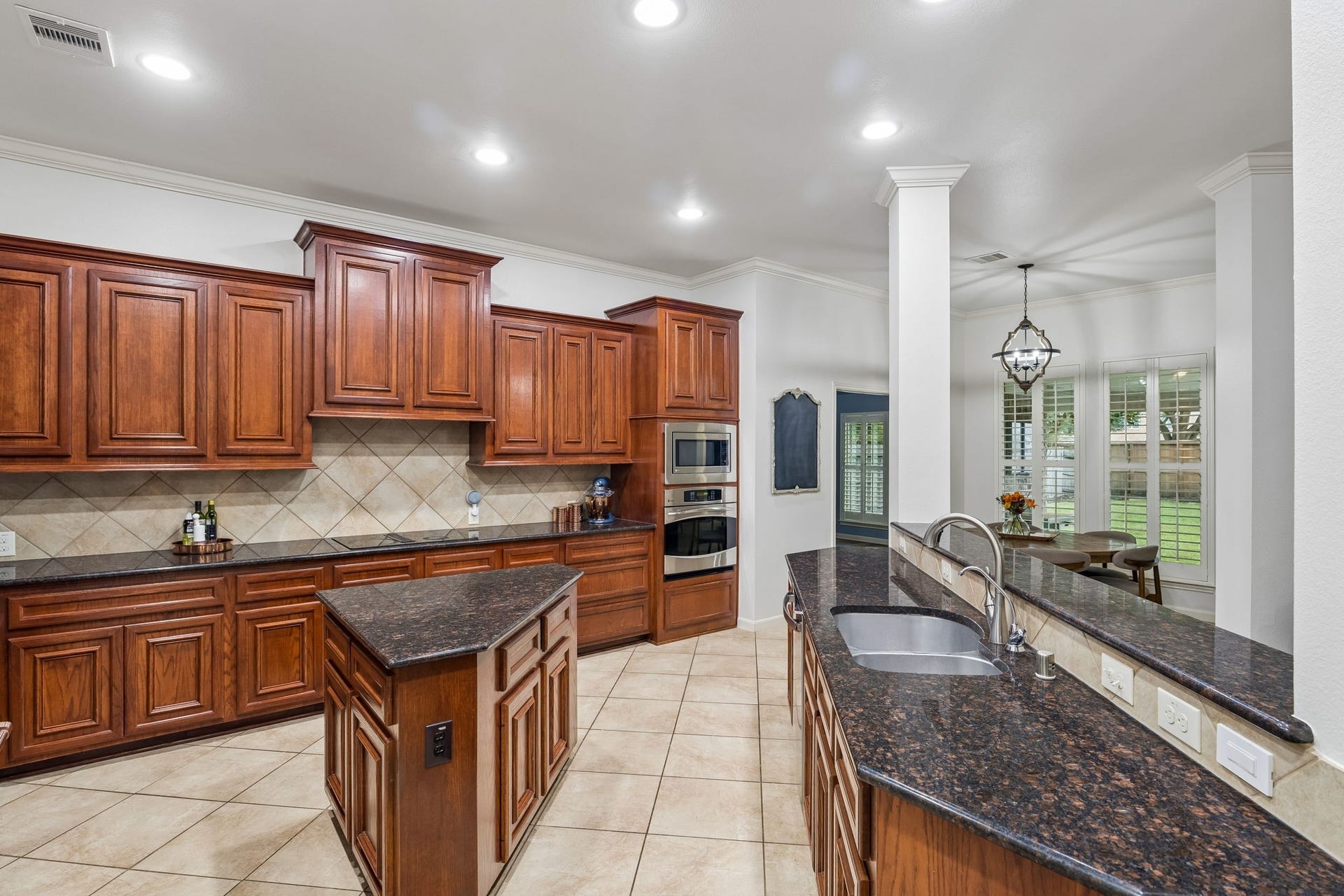 2927 Auburn Creek Lane, League City, TX 77573 Alternate kitchen view highlighting the center island, generous workspace, and abundant cabinetry.