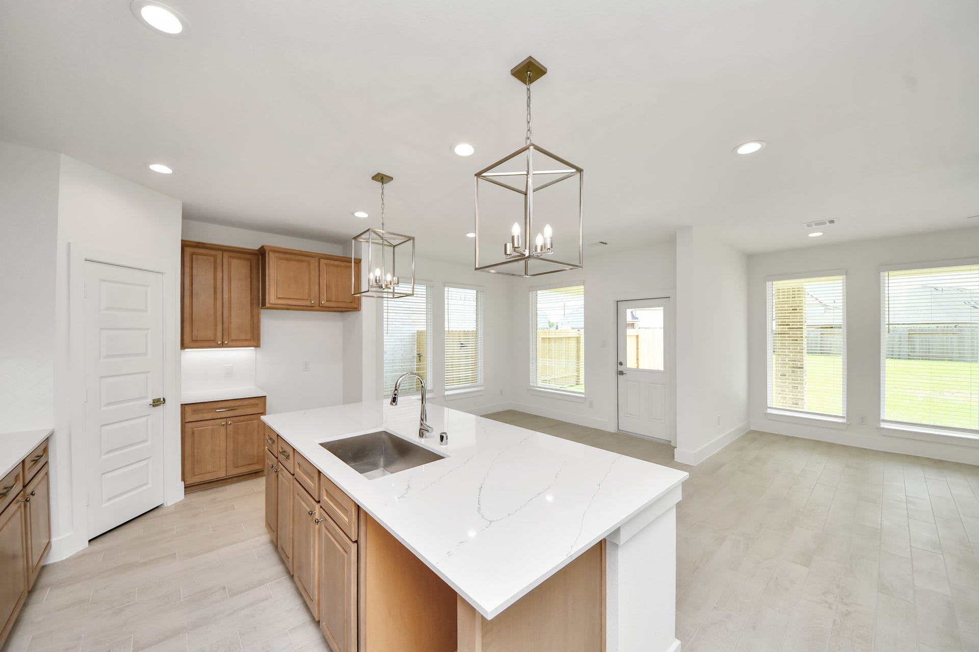 3217 Skerne Spring Drive, Spring, TX 77373 This kitchen is truly a chef's dream! This haven Boasts high ceilings, recessed & pendant lighting, stained wood cabinets, granite countertops, stainless steel appliances, a modern tile backsplash. All of this overlooks your expansive family room, creating a perfect space for culinary delights and family gatherings. Sample photo of completed home with similar floor plan. Actual colors and selections may vary.