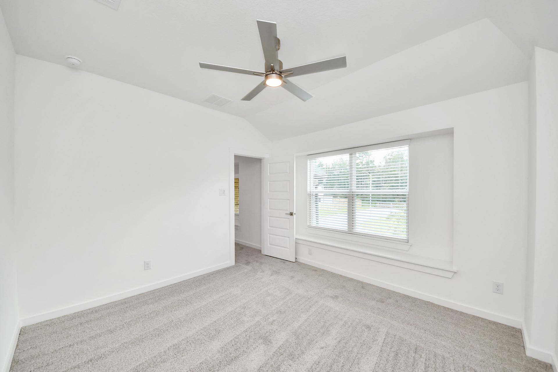 3217 Skerne Spring Drive, Spring, TX 77373 Secondary bedroom features plush carpeting, large windows that let in plenty of natural light, bright paint, and spacious closets. Sample photo of completed home with similar floor plan. Actual colors and selections may vary.
