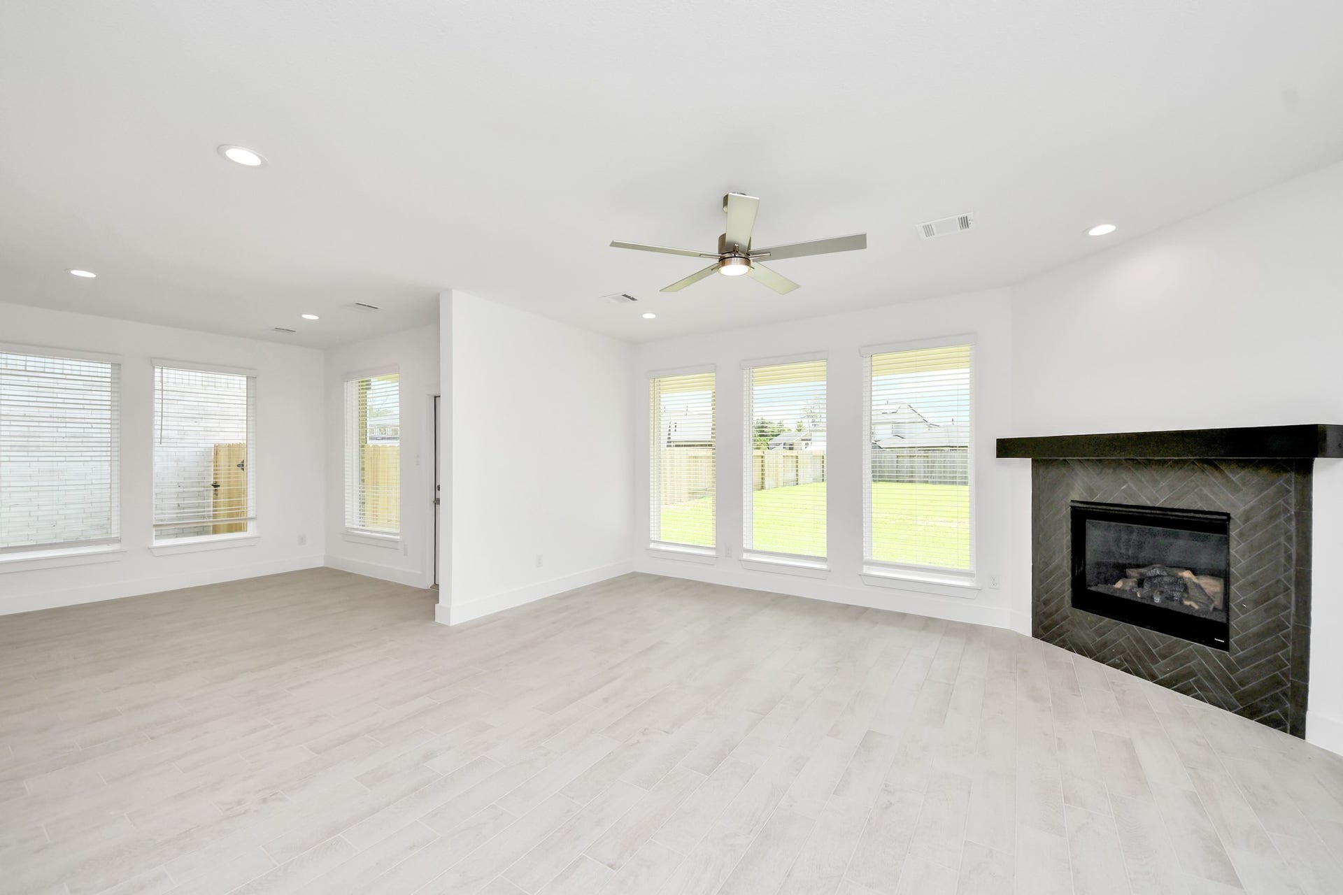3217 Skerne Spring Drive, Spring, TX 77373 Bring your loved ones and guests together in the inviting living room! Boasting lofty high ceilings, recessed lighting, a stylish ceiling fan, custom paint, stunning flooring, and expansive windows that flood the space with ample natural light all day long. Sample photo of completed home with similar floor plan. Actual colors and selections may vary.