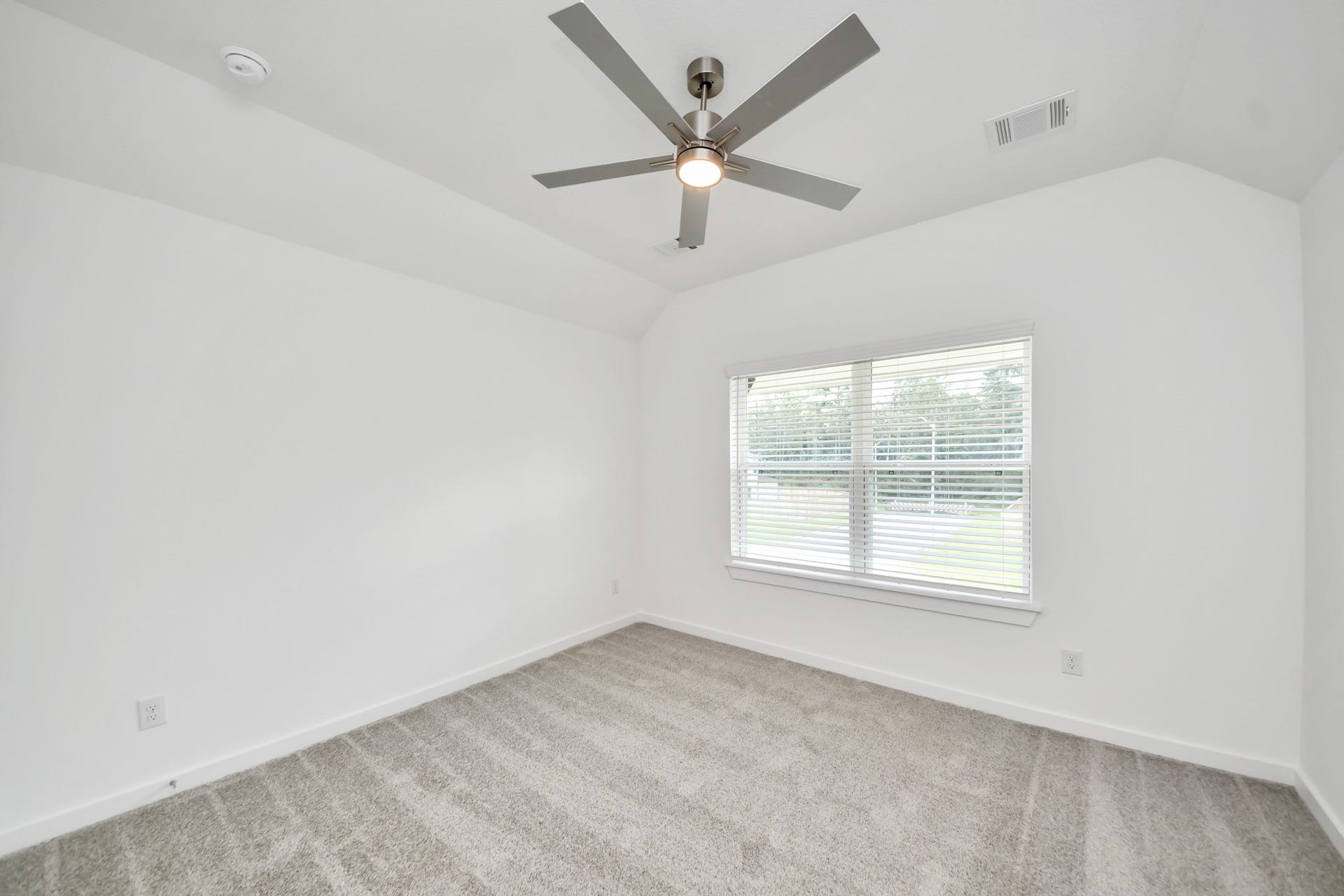 3217 Skerne Spring Drive, Spring, TX 77373 Secondary bedroom features plush carpeting, large windows that let in plenty of natural light, bright paint, and spacious closets. Sample photo of completed home with similar floor plan. Actual colors and selections may vary.