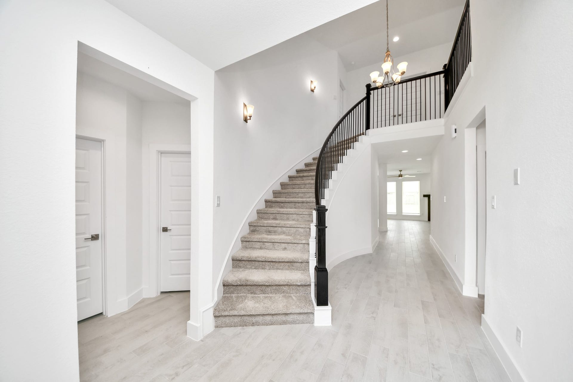 3217 Skerne Spring Drive, Spring, TX 77373 As you step into the threshold of this luxurious home, you'll soon be welcomed by an elegant glass door (to be installed). Inside, soaring ceilings amplify the spaciousness, while the refined wood-look tile flooring and oversized baseboards exude sophistication and charm. Sample photo of completed home with similar floor plan. Actual colors and selections may vary.