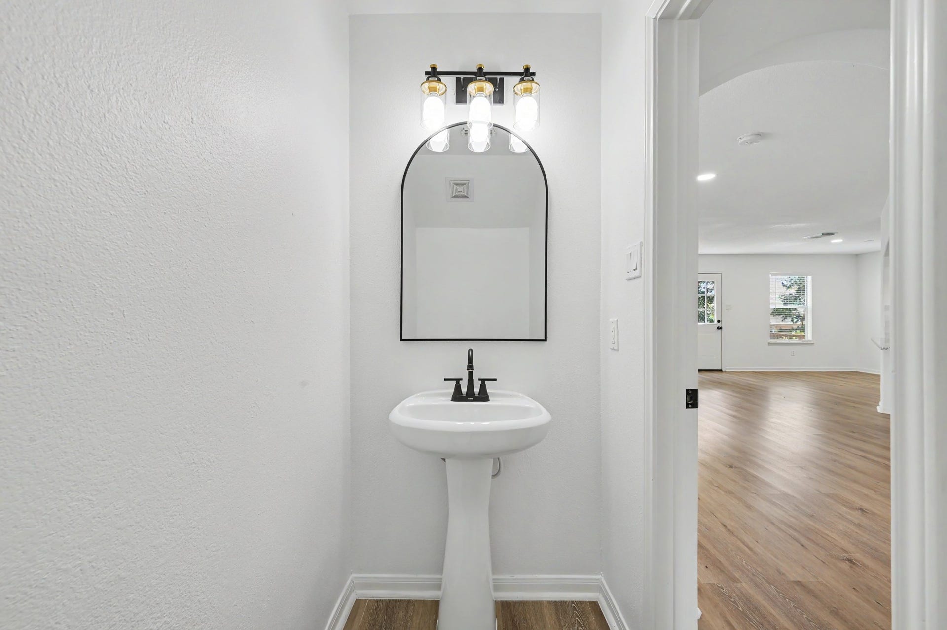 6894 Stillwater Drive, Willis, TX 77318 Half bathroom downstairs.