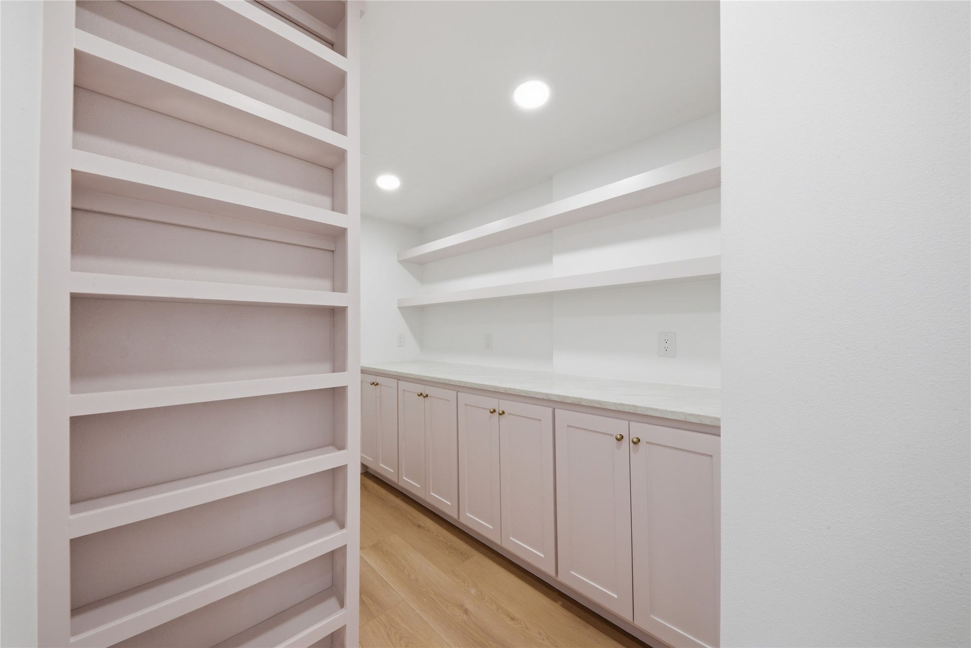 40203 Cimarron Way, Magnolia, TX 77354 Oversized walk-in pantry featuring floor-to-ceiling custom shelving, soft-close lower cabinetry, quartz counter prep space, and recessed lighting. A rare luxury for serious cooks and entertainers.