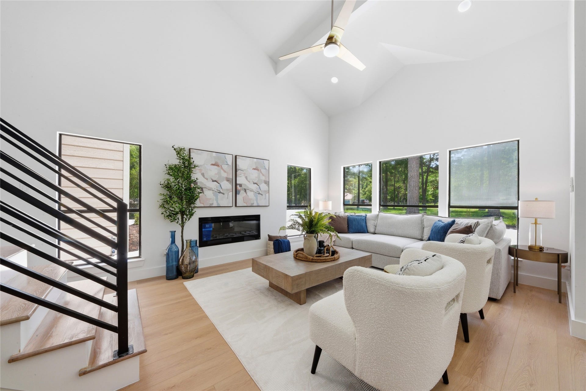 40203 Cimarron Way, Magnolia, TX 77354 Light-filled great room with vaulted 20-ft ceilings, linear fireplace, and panoramic wooded views. Designer ceiling fan, recessed lighting, and oversized windows fill the space with natural light. Luxury vinyl floors flow throughout.