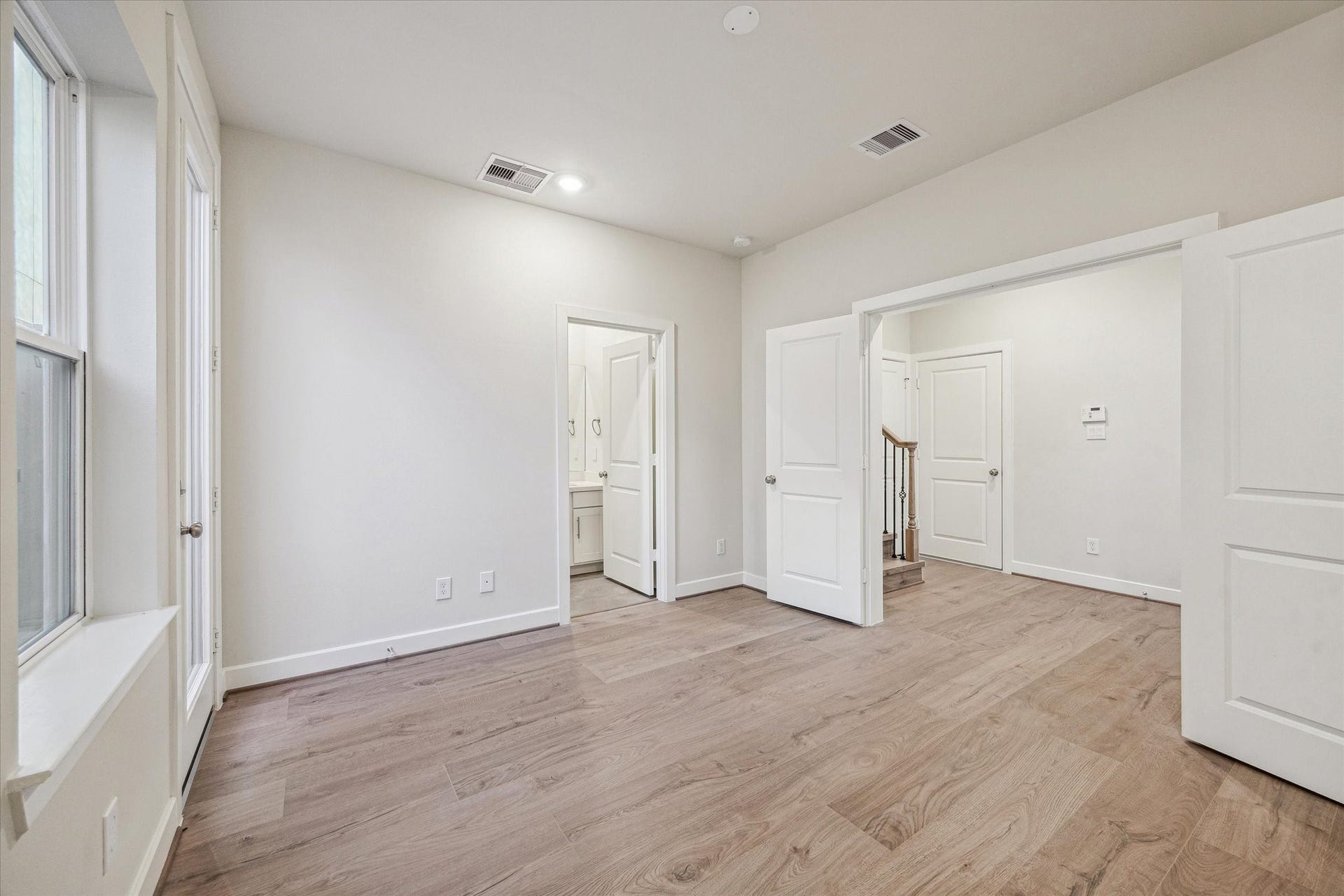 Secondary bedroom featuring large window, and direct access to a private en-suite bath.