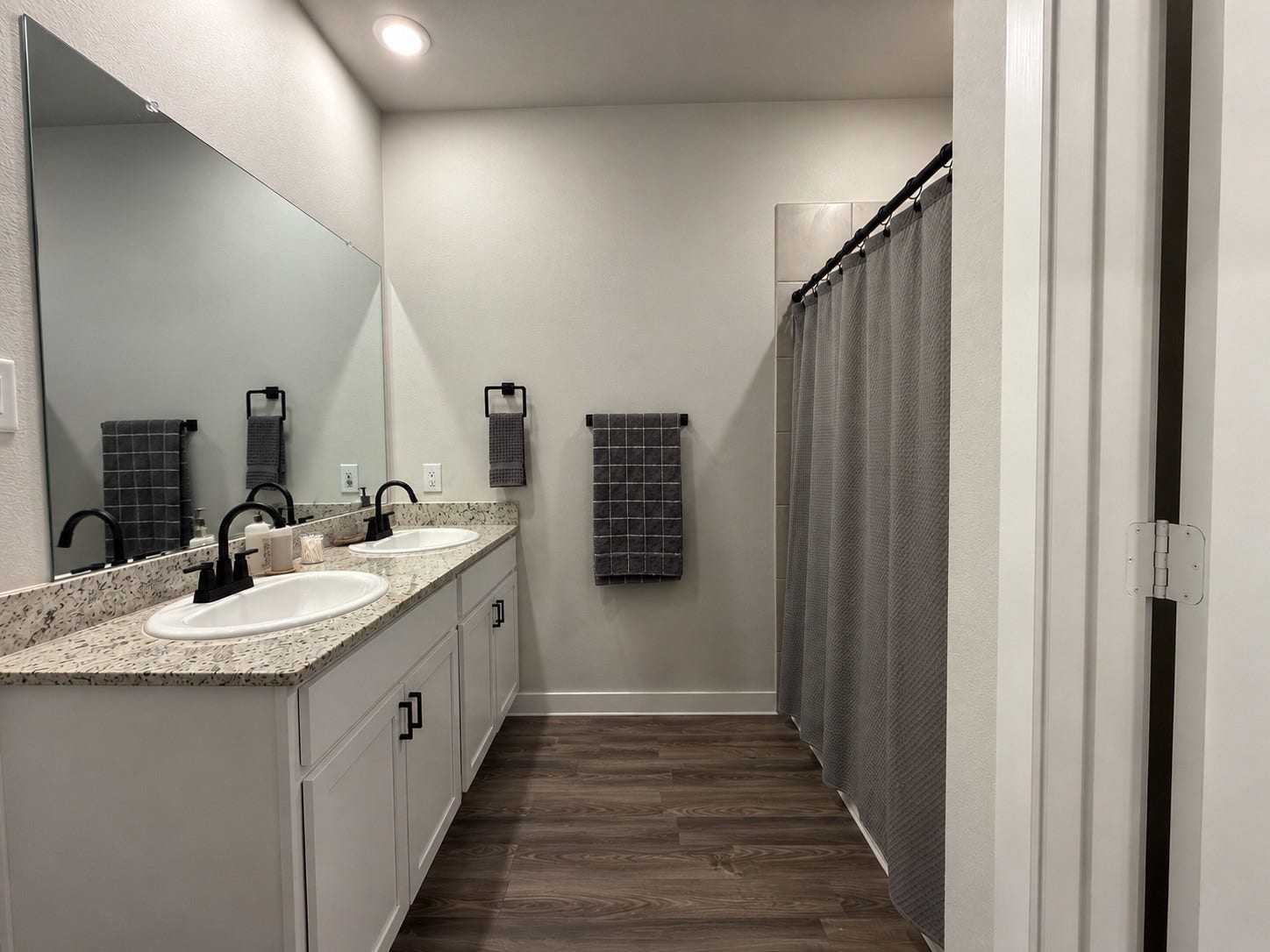 Primary Bathroom with Double Sinks and Shower/Tub Combo