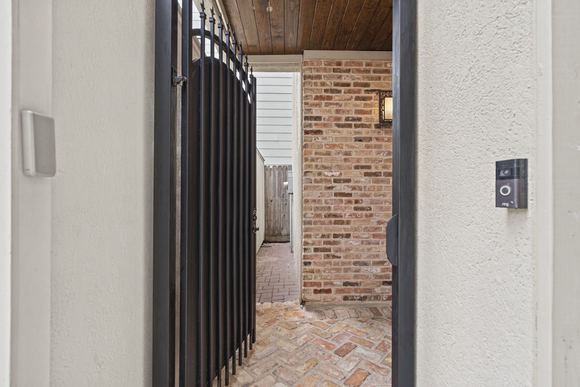 4122 Floyd Street, #A, Houston, TX 77007 Private Entry An elegant wrought-iron gate opens to a brick-clad entryway, where rich textures and Mediterranean architectural details create a warm and inviting first impression.