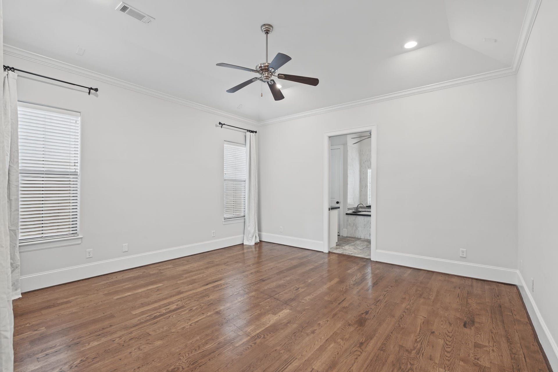 Primary Bedroom [15 x 16]  Third Floor. A peaceful retreat above the homes gathering spaces, the primary suite offers generous proportions, a spacious walk-in closet, and access to a private balcony overlooking the courtyard. An inviting place to begin and end each day.