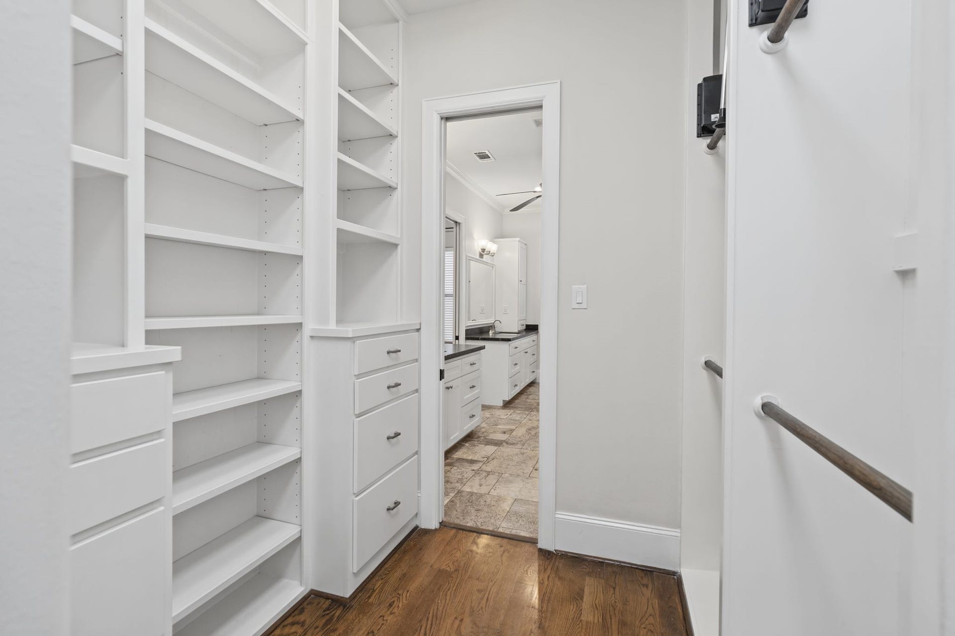 4122 Floyd Street, #A, Houston, TX 77007 Primary Walk-In Closet Third Floor. Beautifully appointed with floor-to-ceiling custom built-ins, this spacious dressing room offers thoughtfully organized storage and a boutique-inspired setting for the everyday ritual of getting ready.