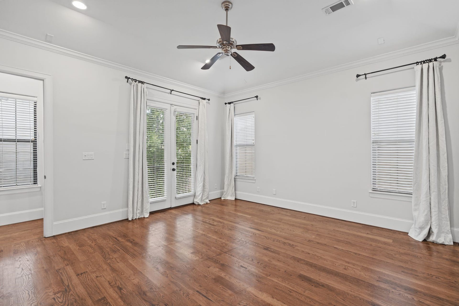 Primary Bedroom [15 x 16]  Third Floor. A peaceful retreat above the homes gathering spaces, the primary suite offers generous proportions, a spacious walk-in closet, and access to a private balcony overlooking the courtyard. An inviting place to begin and end each day.
