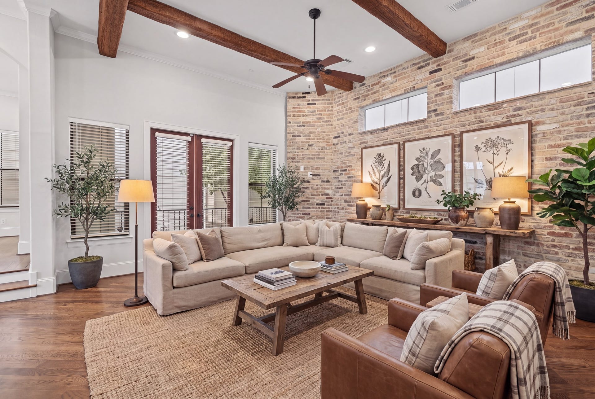 Living Room [16 x 16]  Second Floor. Architectural character takes center stage with exposed wood ceiling beams, rich brick-clad accents, and beautiful natural light. An inviting setting for relaxed evenings or entertaining, where timeless textures lend warmth and distinction. Disclaimer: This room has been virtually staged.