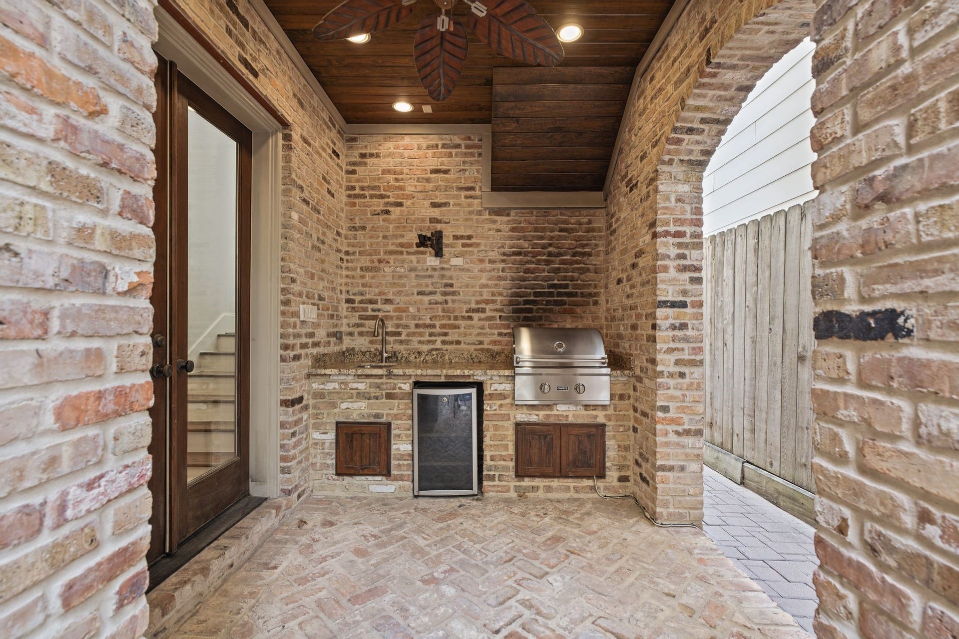 4122 Floyd Street, #A, Houston, TX 77007 Summer Kitchen Courtyard Graceful brick arches frame this inviting outdoor culinary retreat, complete with a built-in Coyote grill, preparation sink, and beverage refrigerator. Just steps from the private plunge pool, it sets the scene for leisurely afternoons, alfresco dining, and memorable evenings with friends.