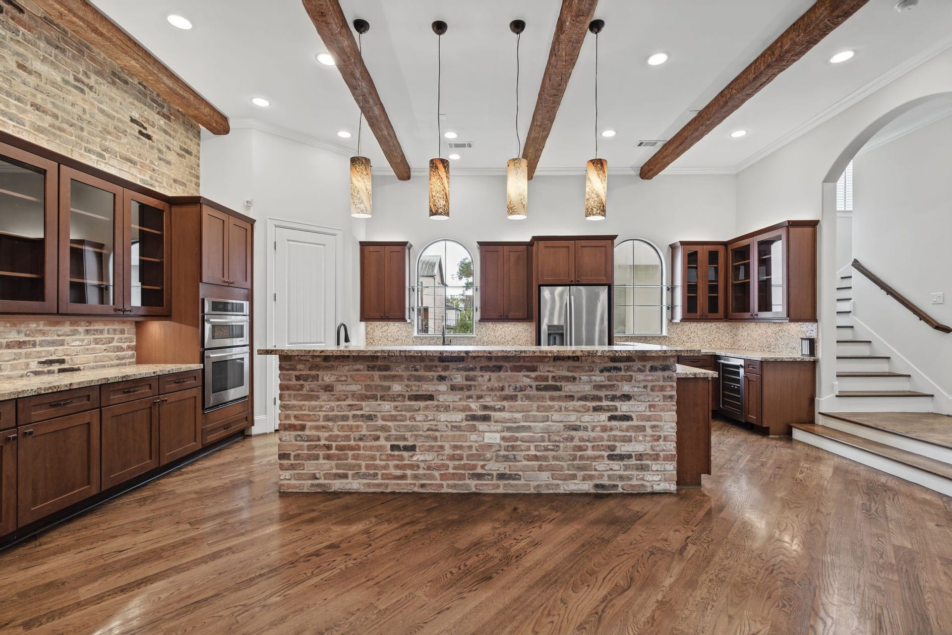 Kitchen [24 x 12]  Second Floor. Designed for those who appreciate the art of cooking and entertaining, this expansive kitchen pairs leathered granite countertops with professional-grade Jenn-Air appliances, glass-inset cabinetry, and a generous 4 x 6 island.