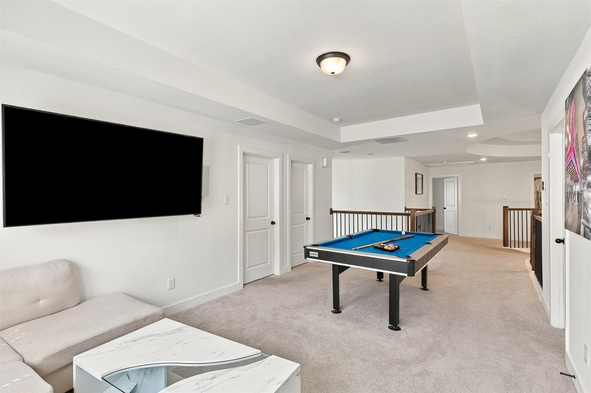 2922 Opal Ivory Way, Richmond, TX 77406 Spacious entertainment loft featuring a pool table, wall-mounted TV, and comfortable seating, perfect for relaxation and fun.