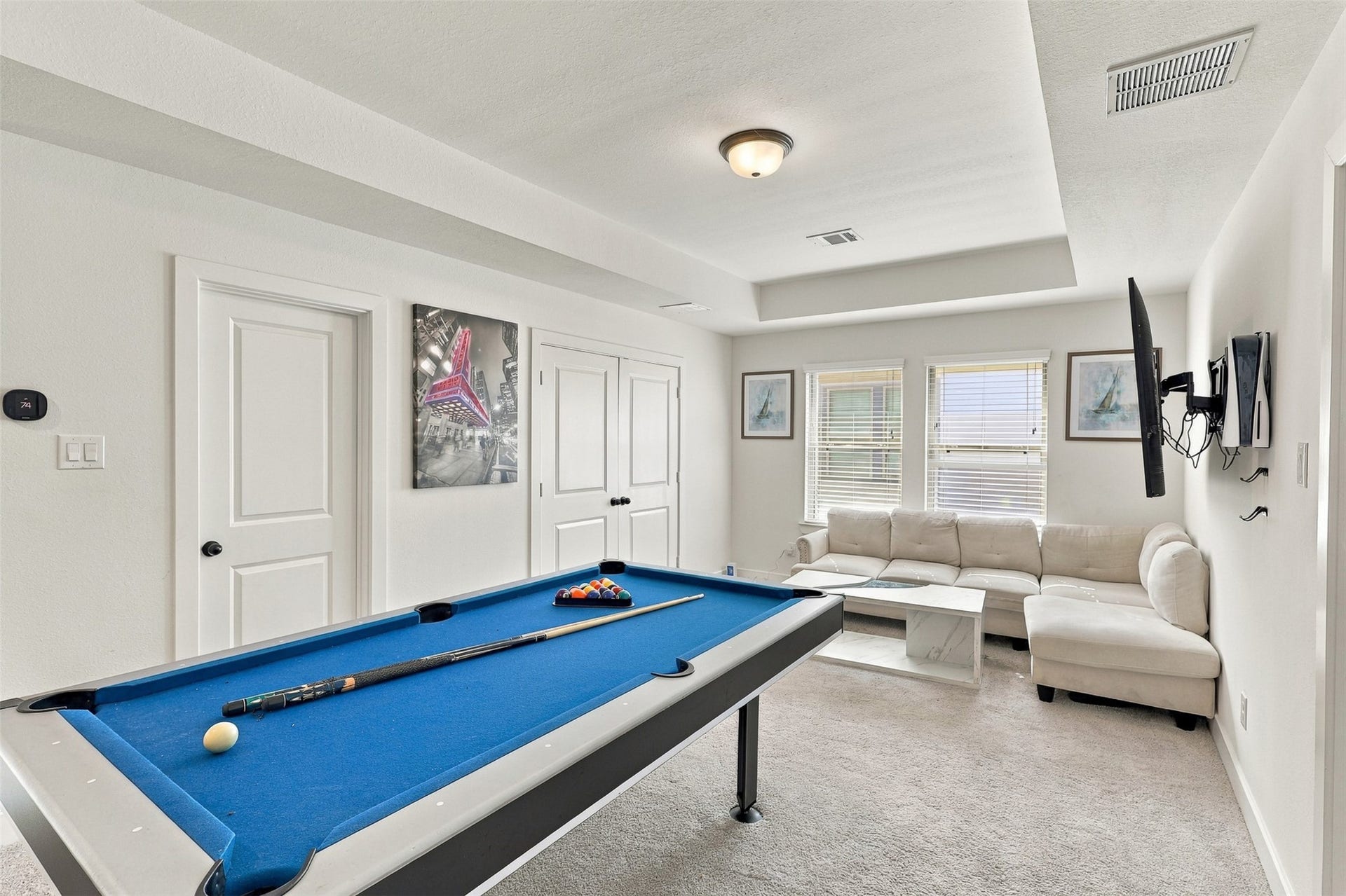 2922 Opal Ivory Way, Richmond, TX 77406 Spacious game room featuring a stylish pool table, cozy sectional sofa, and mounted TV, perfect for entertainment and relaxation.