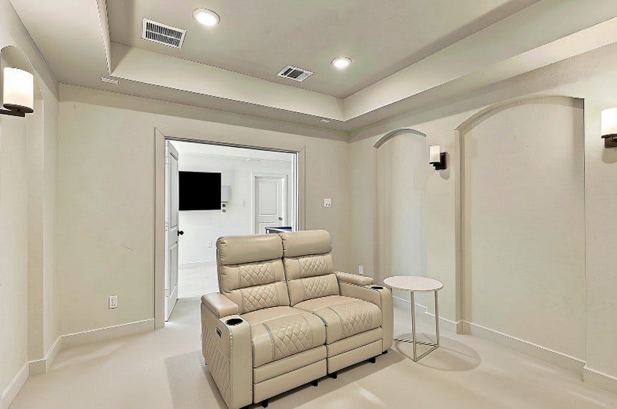 2922 Opal Ivory Way, Richmond, TX 77406 Cozy media room featuring plush recliner seating, soft lighting, and an inviting neutral palette, perfect for entertainment and relaxation.