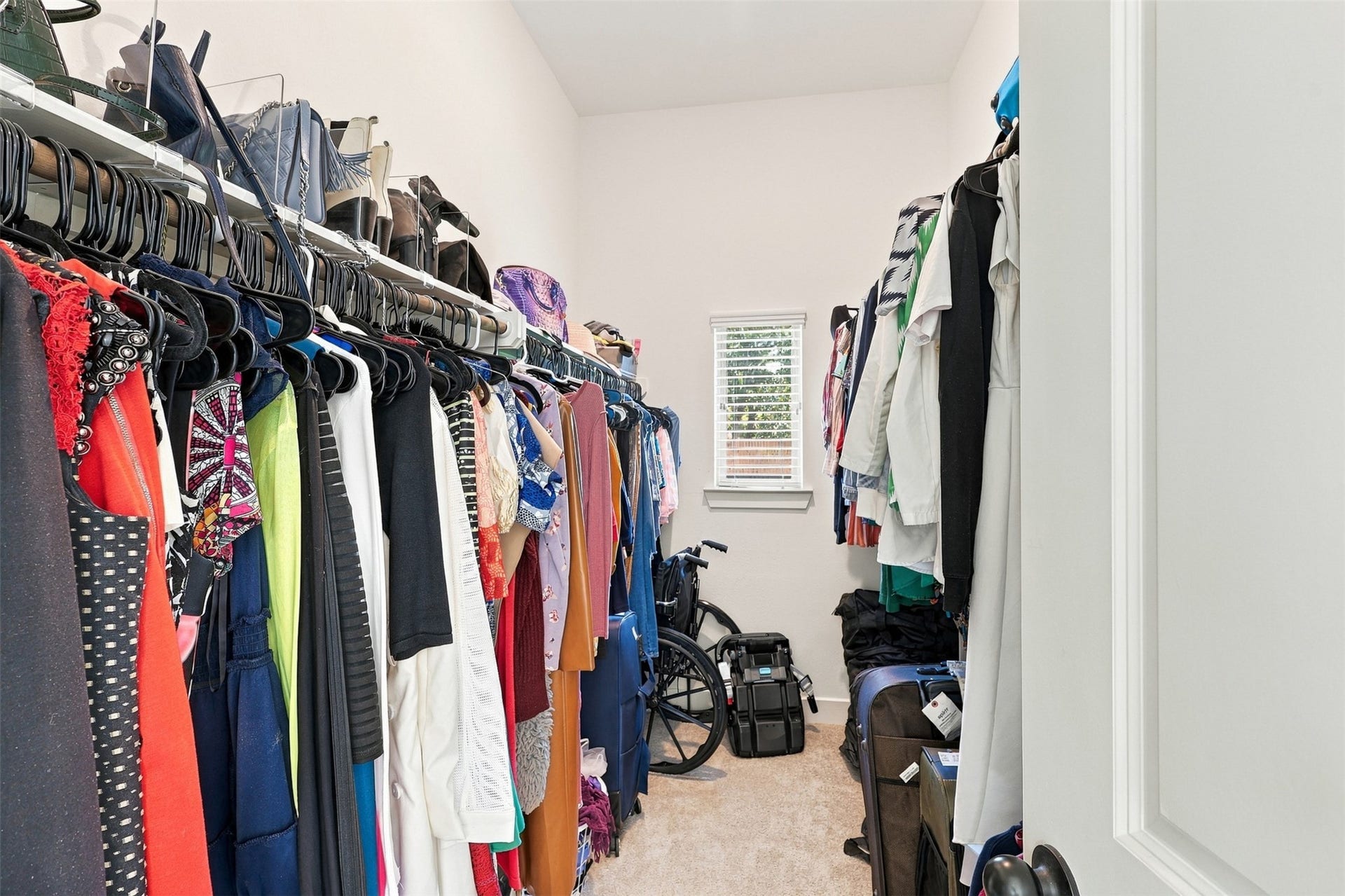2922 Opal Ivory Way, Richmond, TX 77406 Spacious walk-in closet with ample hanging space, shelving for accessories, and a window for natural light.