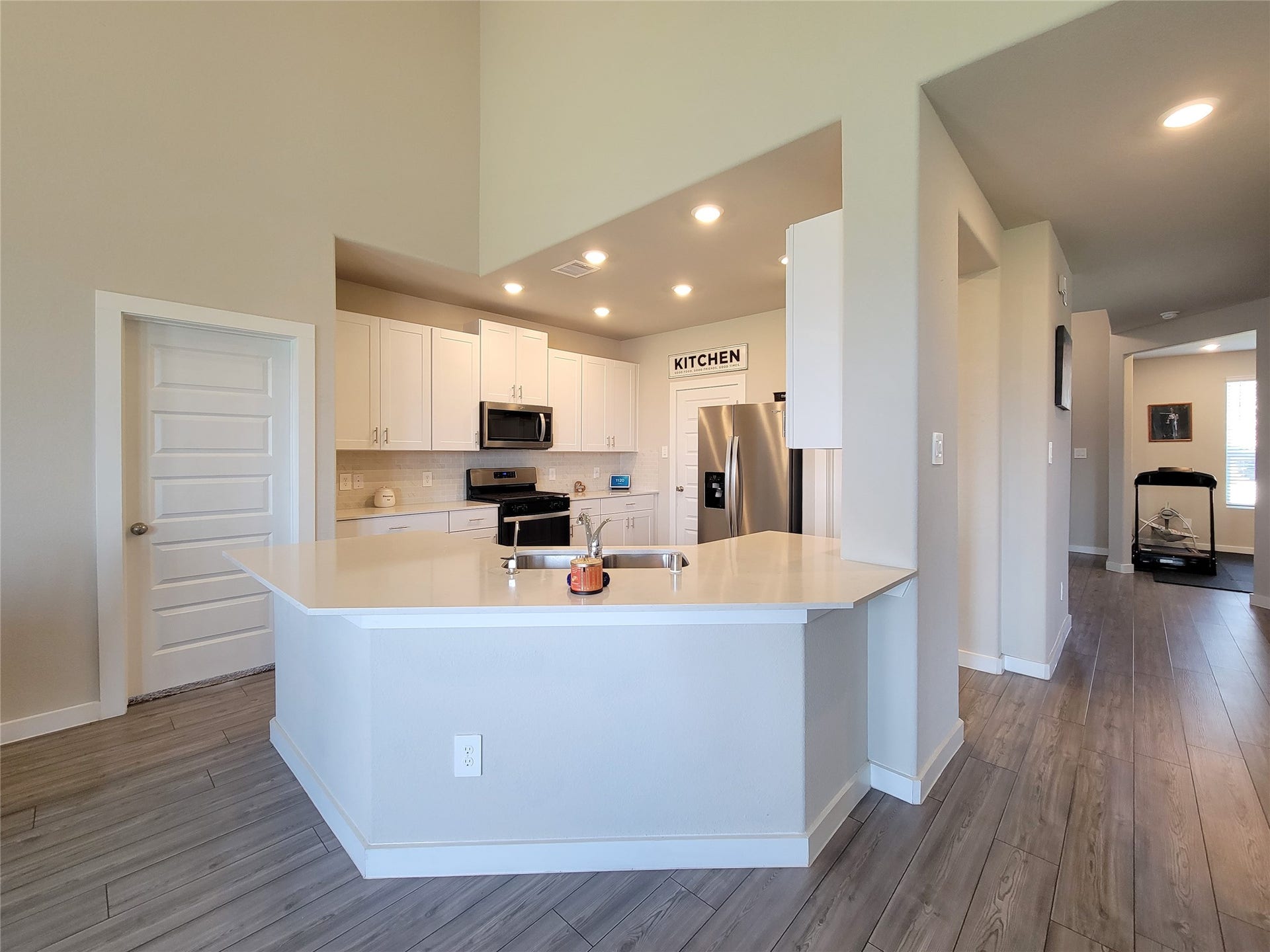 10843 Bodie Hills Drive, Rosharon, TX 77583 Modern kitchen with sleek stainless steel appliances, white cabinetry, and a spacious peninsula countertop, perfect for cooking and entertaining.