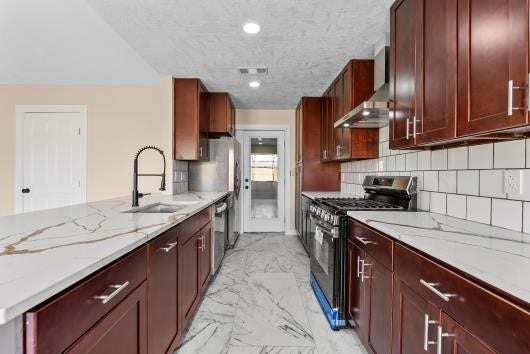 11007 Green Arbor Drive, Houston, TX 77089 Modern kitchen with dark wood cabinets, quartz countertops, and all new stainless steel appliances, makes cooking a dream.