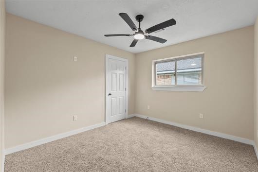 11007 Green Arbor Drive, Houston, TX 77089 bedroom #2 with new carpets, windows, and ceiling fans