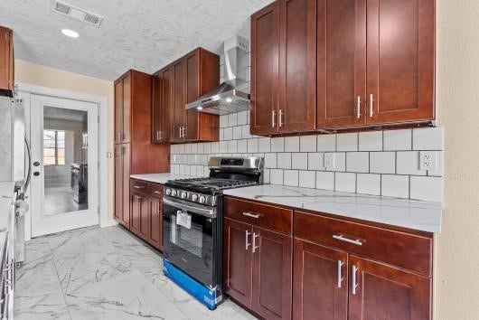 11007 Green Arbor Drive, Houston, TX 77089 All new appliances including gas stove, refrigerator, dishwasher, and modern tyle flooring highlight this large kitchen,