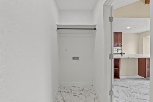 11007 Green Arbor Drive, Houston, TX 77089 This photo shows a small, tiled laundry area with a hook-up for appliances, adjacent to an open kitchen space.
