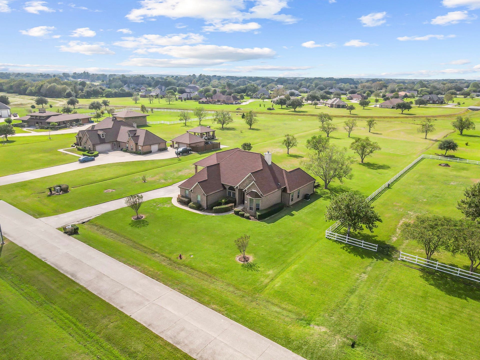 11010 Madison Court, Beaumont, TX 77705 This aerial view highlights the generous spacing between neighboring properties, expansive lawns, and beautiful open surroundings. Situated on over 2 acres, this home offers a wonderful balance of privacy, space, and peaceful country-style living.