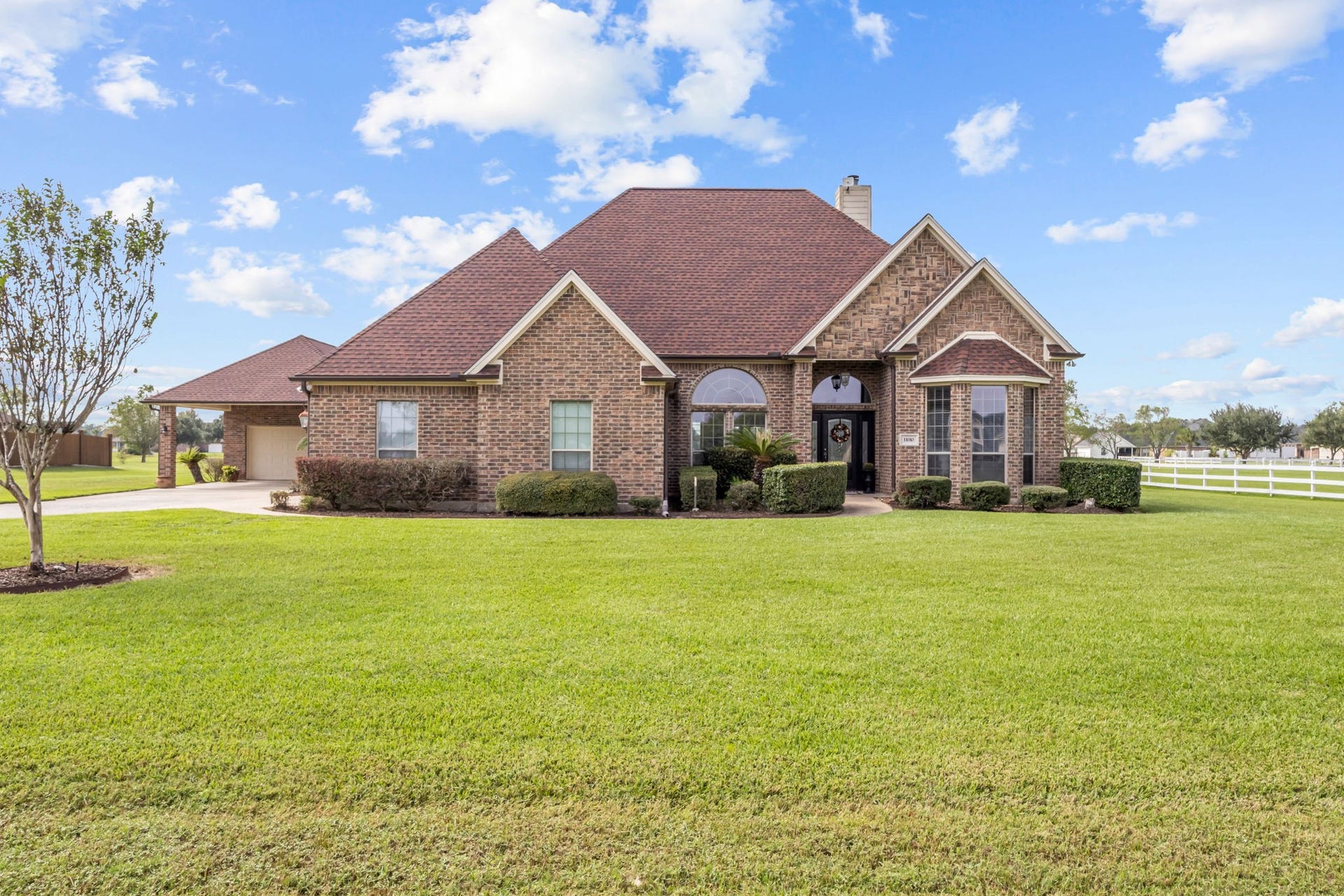 11010 Madison Court, Beaumont, TX 77705 Beautiful brick home featuring impressive architectural details, a welcoming covered entry, and a spacious, well-maintained front lawn. Mature landscaping, an extended driveway, and a detached garage enhance the property's curb appeal.