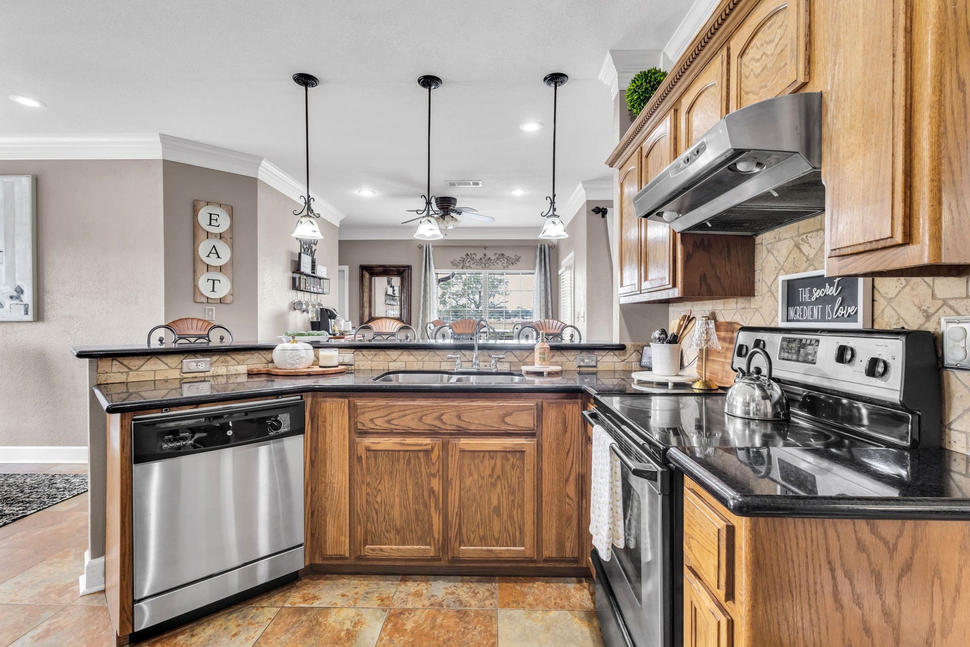 11010 Madison Court, Beaumont, TX 77705 Kitchen offers plenty of cabinet and counter space, a double sink, and a decorative tile backsplash. The open breakfast bar connects to the dining area, making the space convenient for everyday living and entertaining.